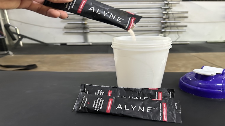 Our tester mixing a single serving of Alyne Pre-Workout