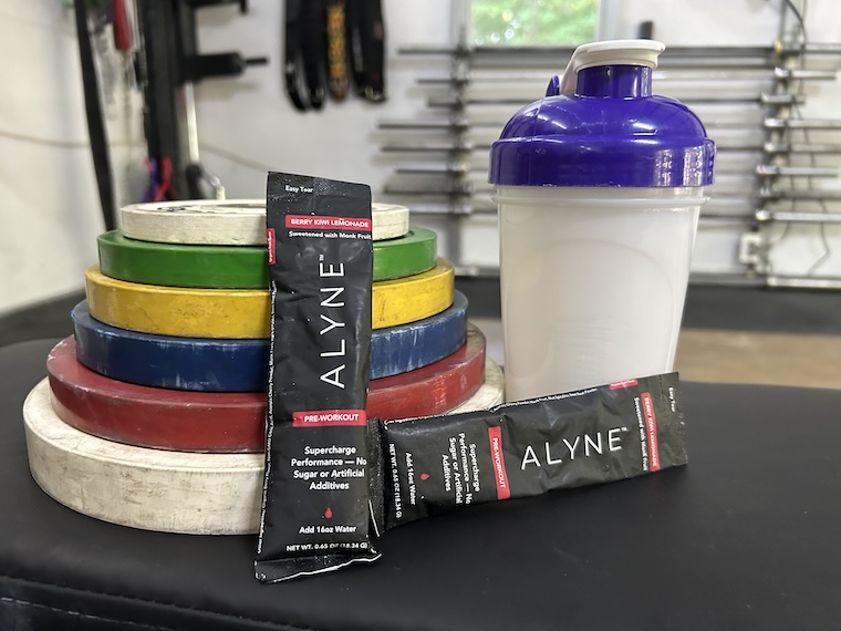 Alyne Pre-Workout on a bench in our tester's garage gym.