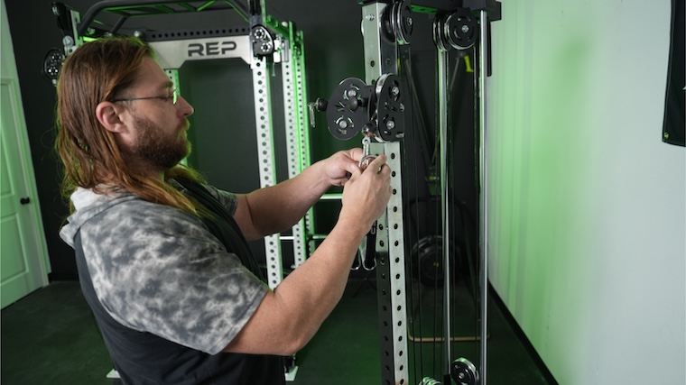 Our tester connecting an attachment to the Bells of Steel Plate Loaded Cable Tower