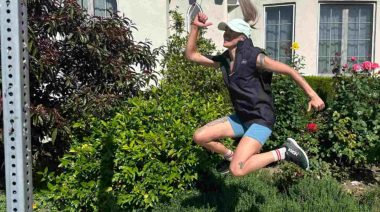 Our tester jumps for joy in one of the Best Running Vests.