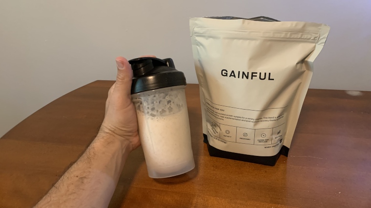 Our tester holds up a shake made with Gainful Protein Powder