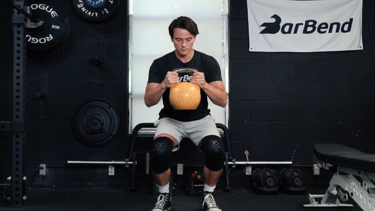 Our tester squats with a kettlebell while wearing Iron Bull Knee Sleeves on his knees.