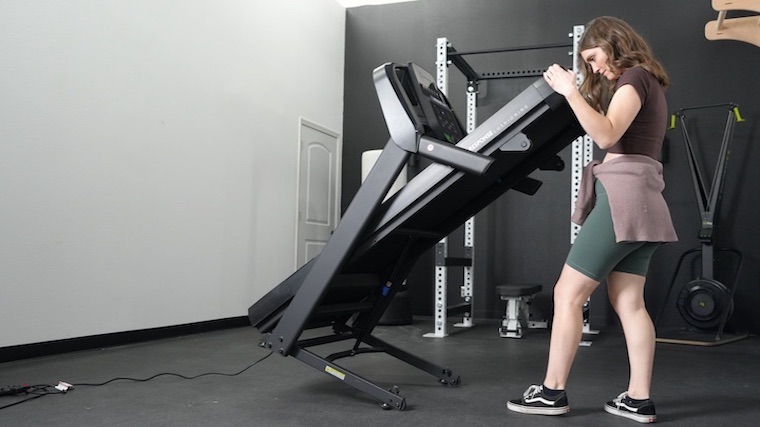 Our tester unfolding the Horizon T101 Treadmill.