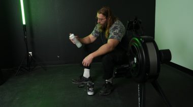 A BarBend tester shaking up creatine after a workout.