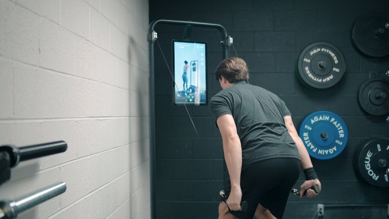 A BarBend tester working out with the Speediance Home Gym.