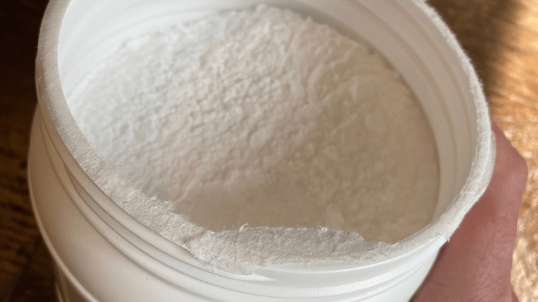 Looking into an opened tub of Thorne Creatine Powder