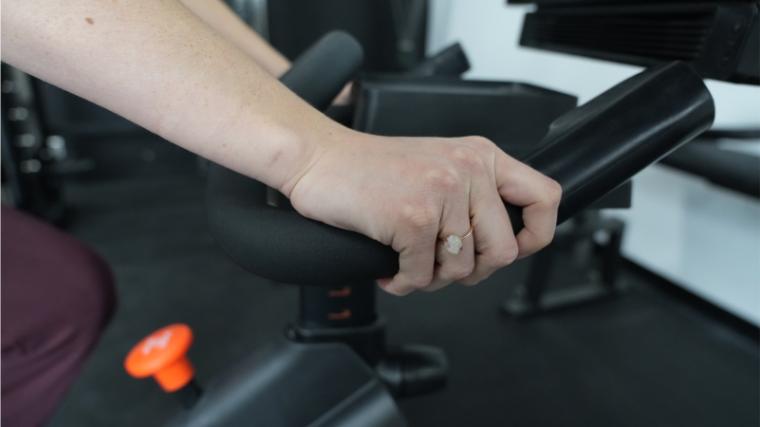 Our tester gripping the handlebars on the NordicTrack S22i.