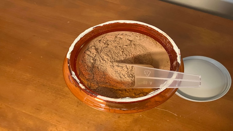 An open container of NOW Sports Whey Protein Isolate