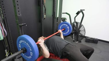 Our tester bench pressing the Synergee Games Cerakote Barbell