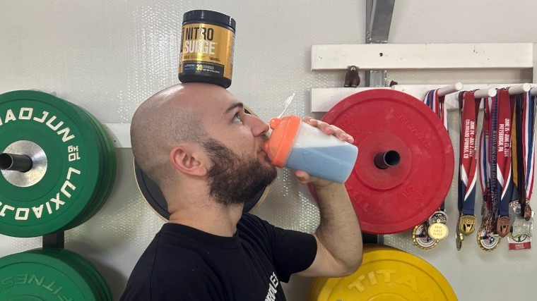 Our tester drinks NitroSurge while balancing the container on his head