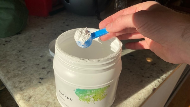 Our tester holds a scoop of Thorne Creatine