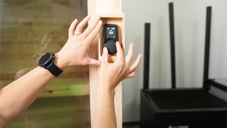 Woman adjusts temperature on the Plunge Sauna