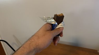 Our tester holding Pure Protein Protein Bars after taking a bite.