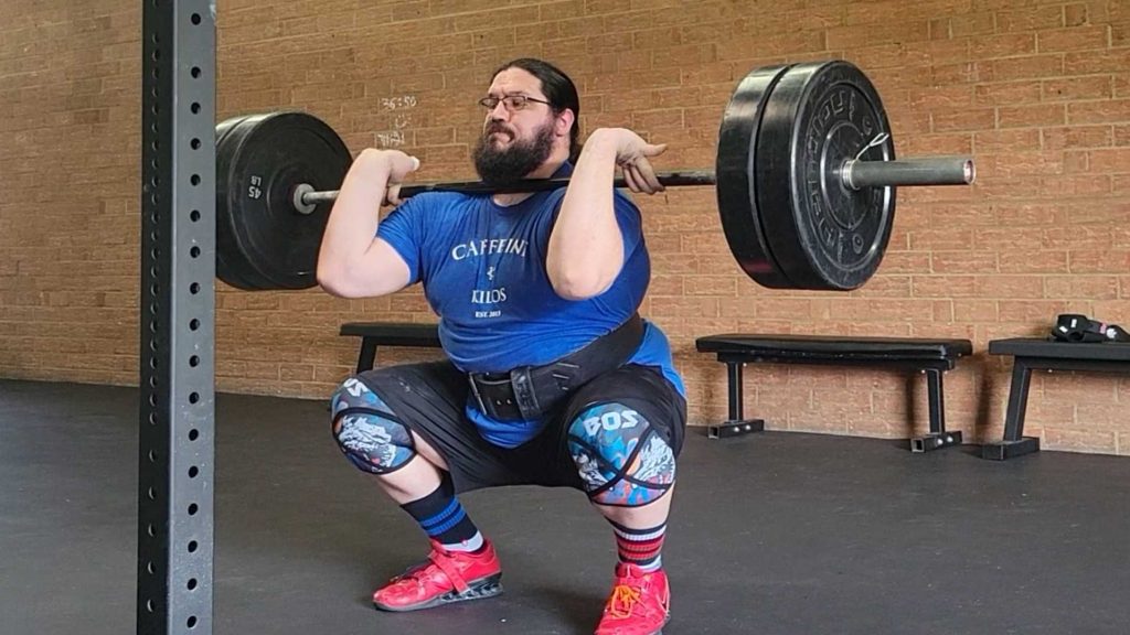 A weightlifting wearing the REP Fitness Premium Leather Lifting Belt in the BarBend gym.