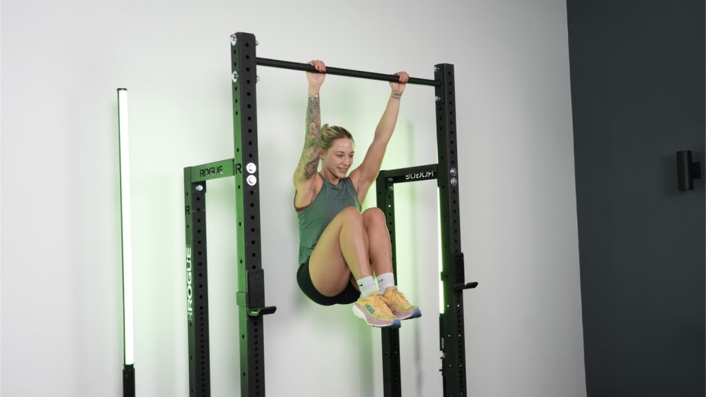 A person hanging from the Rogue HR-2 Half Rack.