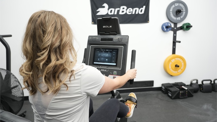 Our tester viewing the 10.1-inch LCD touchscreen featured on the Sole LCR Exercise Bike