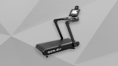 The Sole ST90 Treadmill is shown on a stylized grey background.