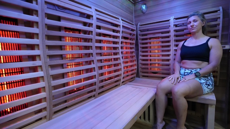 Our tester sitting in the Sun Home Saunas Luminar 5-Person Outdoor Sauna