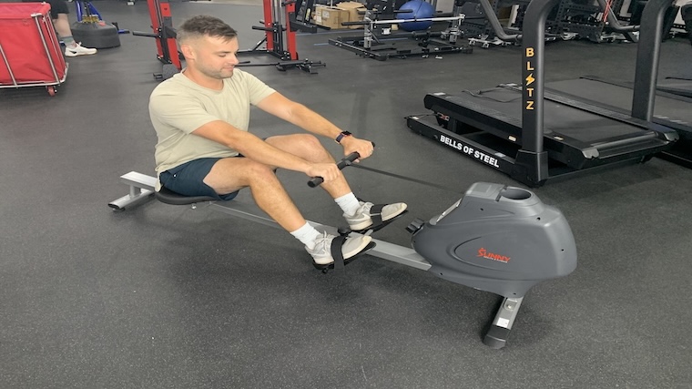 Our tester training atop the Sunny Health & Fitness SPM Magnetic Rowing Machine