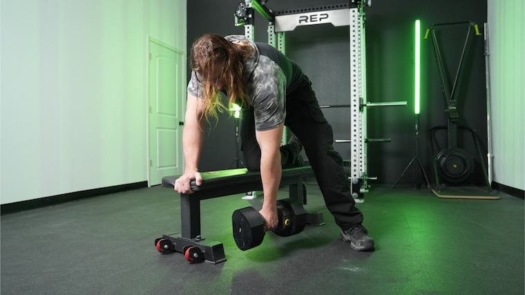 Our tester training atop the Titan Fitness Elite Series Single Post Flat Bench