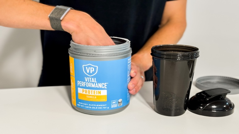 Our tester grabbing a scoop of Vital Proteins Vital Performance Protein Powder