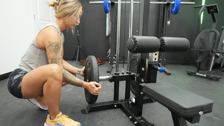 Our tester changing weights on the Giant Fitness GGPR 2.0 with Low Row