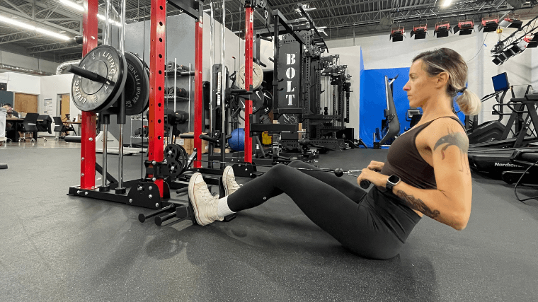 A woman does rows on the Major Fitness Raptor 22.