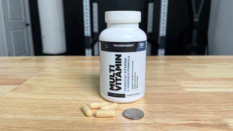 Transparent Labs Multivitamin capsules next to a quarter.