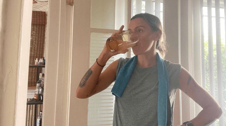 Woman hydrates on a hot day with a Nuun Sport hydration tablet in some water